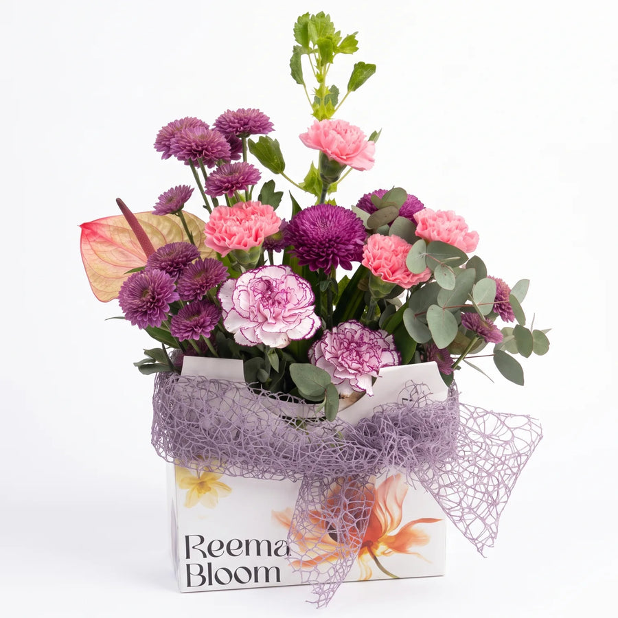 Reema Bloom Mixed-Color Floral Arrangement – Fresh-Cut Flowers with Green Foliage and Decorative Mesh Wrapping
