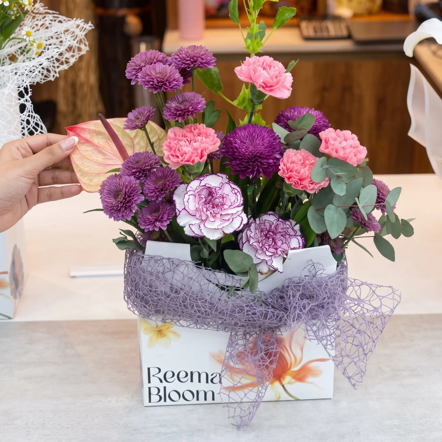 Reema Bloom Mixed-Color Floral Arrangement – Fresh-Cut Flowers with Green Foliage and Decorative Mesh Wrapping